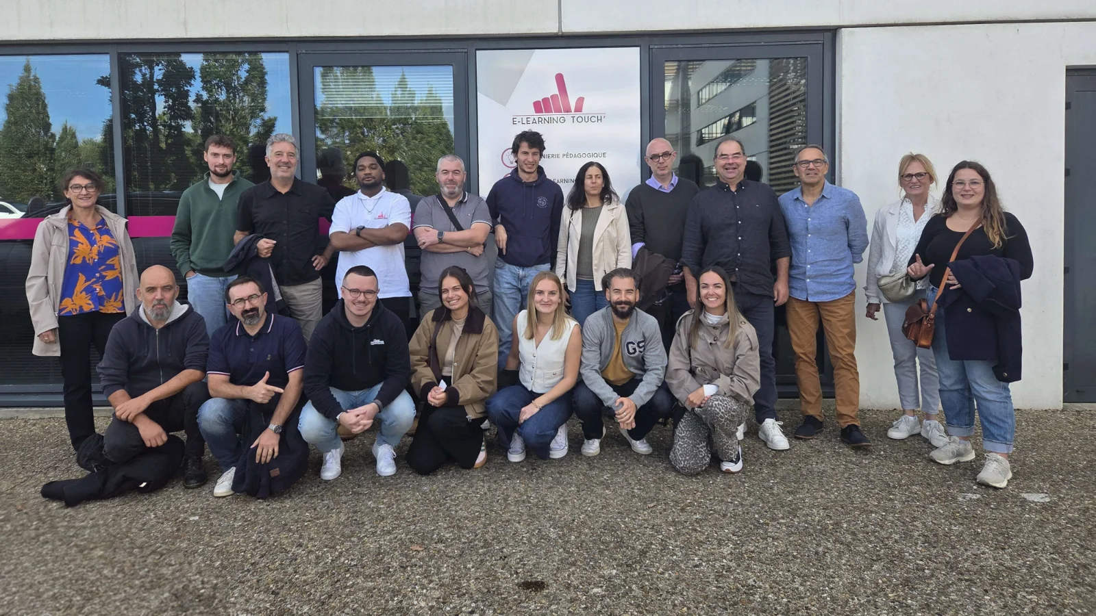 The E-learning Touch' team gathered in front of its offices in Guipavas, under the company sign.